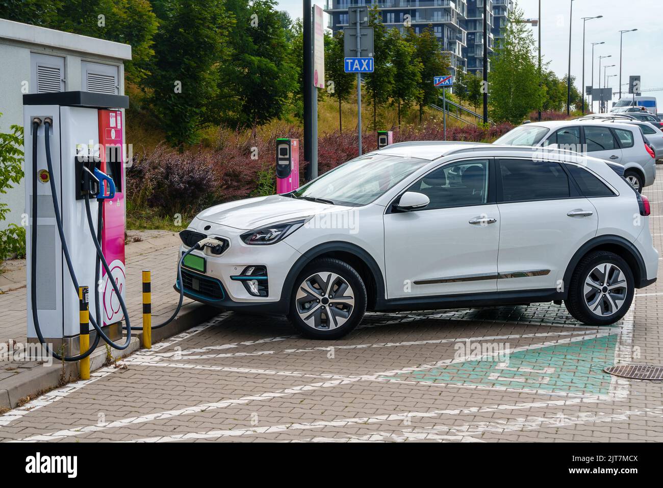 Electric cars plugged into a charging station to charge their batteries