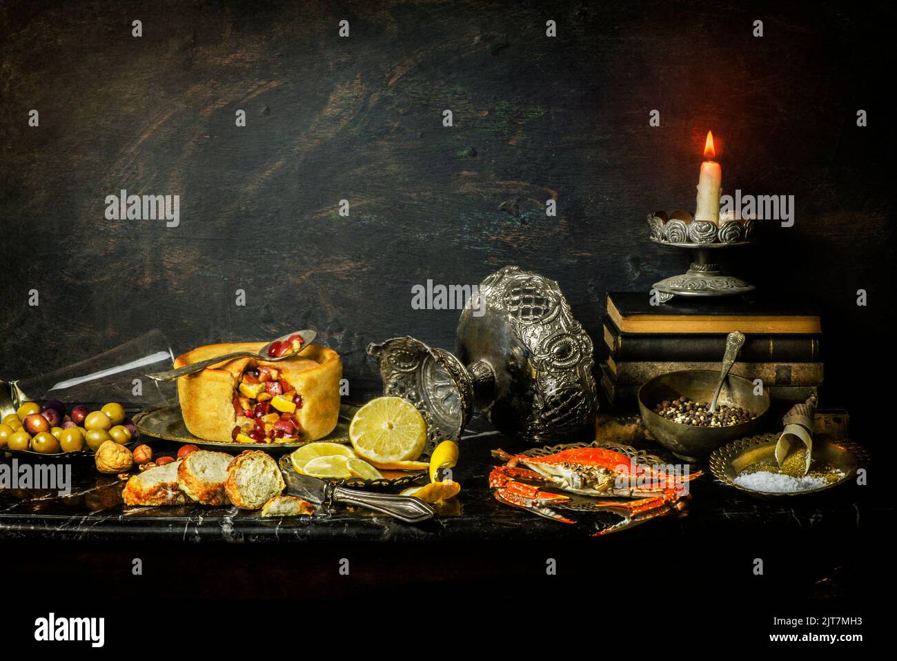 Classic still life with fresh fruit pie placed with olives, bread, steamed crab and herbs on marble background. Stock Photo