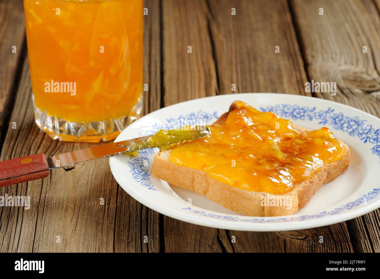 Toast with orange marmalade on wooden background closeup macro horizontal Stock Photo