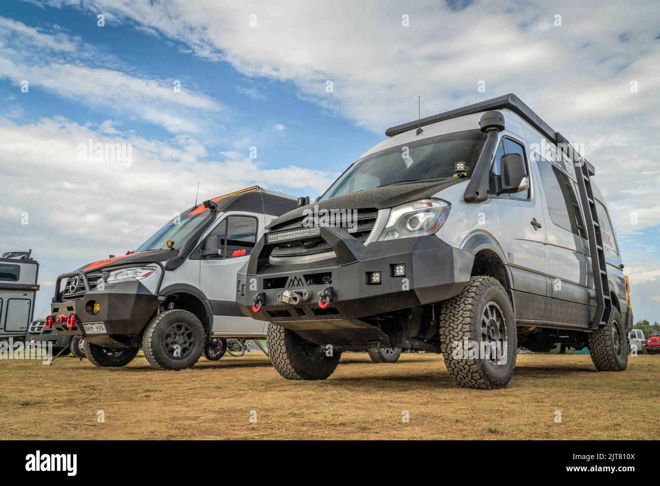 Loveland, CO, USA - August 26, 2022: 4x4 camper vans on Mercedes Sprinter chassis with upgraded suspension and front bumpers for off-road overlanding. Stock Photo