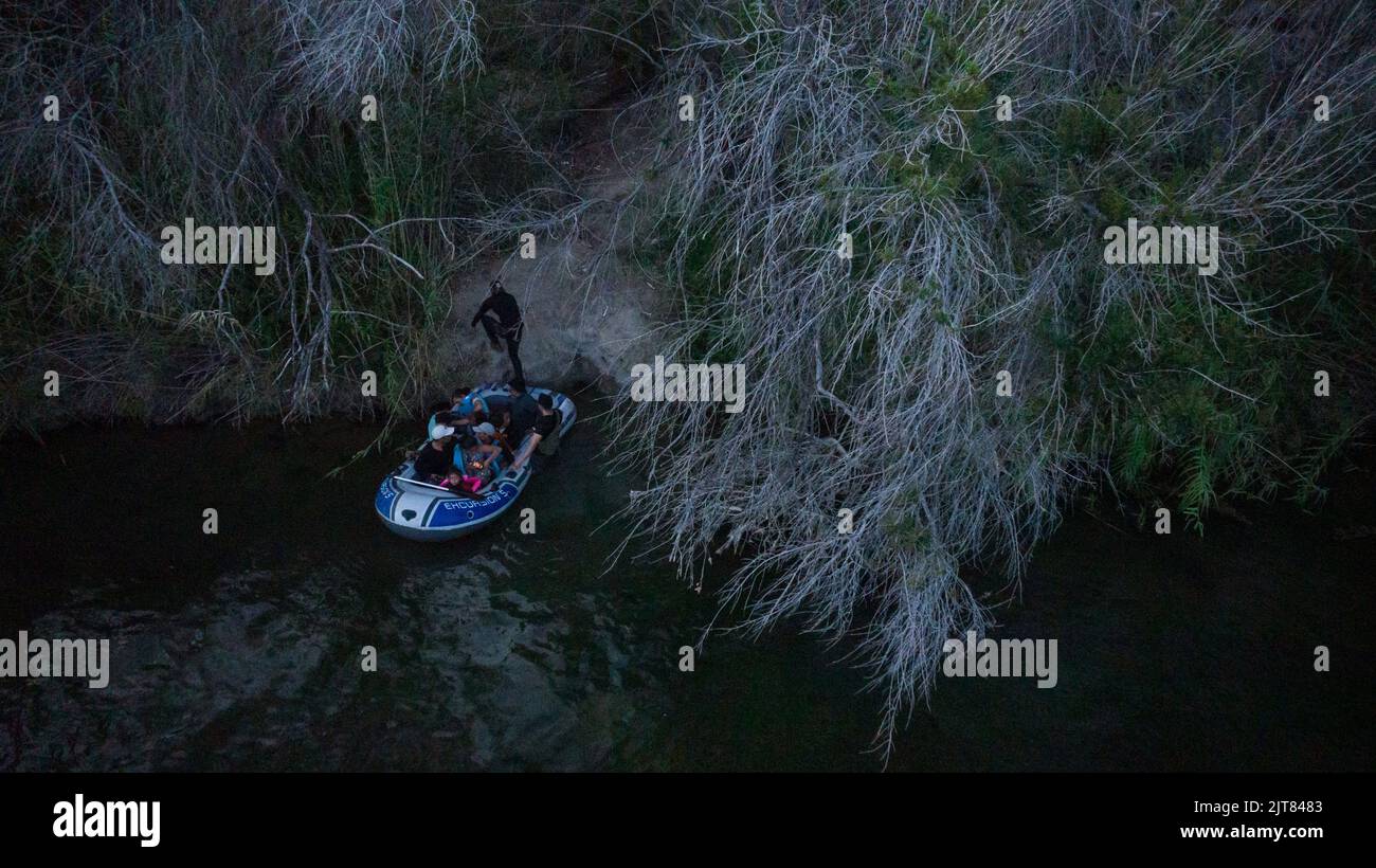 A migrant man exits a raft after being smuggled across the Rio Grande river into Roma, Texas, U.S., August 27, 2022.  REUTERS/Adrees Latif Stock Photo