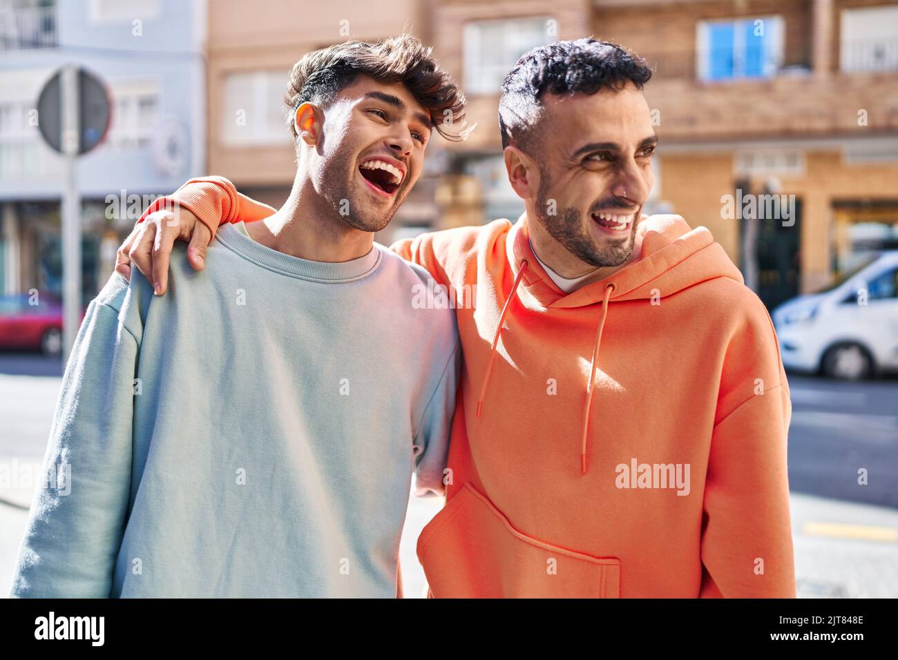 Two man couple hugging each other standing at street Stock Photo - Alamy