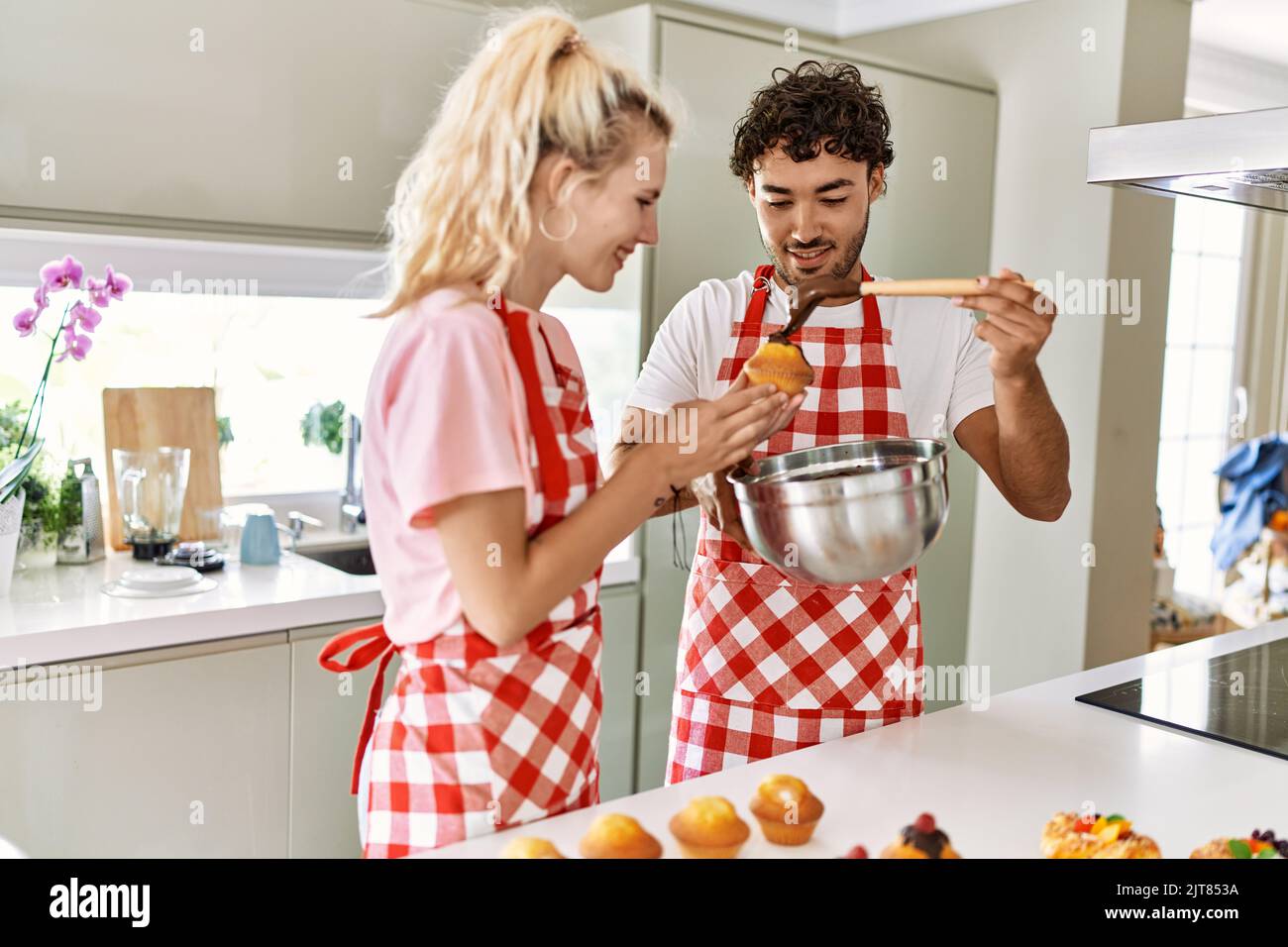 Young couple smiling happy cooking sweets at kitchen Stock Photo - Alamy