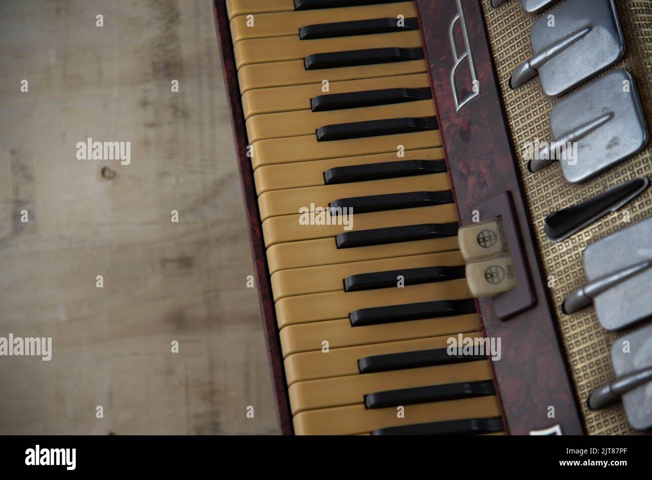Old red accordion. Wind musical instrument. Old concertina. Musical