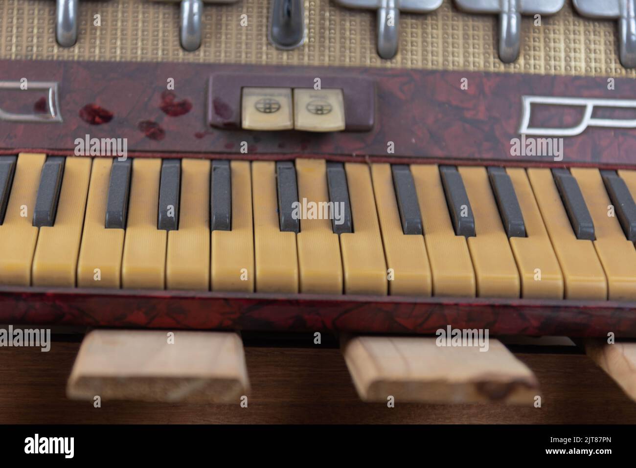 Old red accordion. Wind musical instrument. Old concertina. Musical