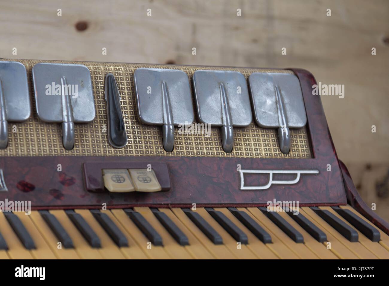 Old red accordion. Wind musical instrument. Old concertina. Musical