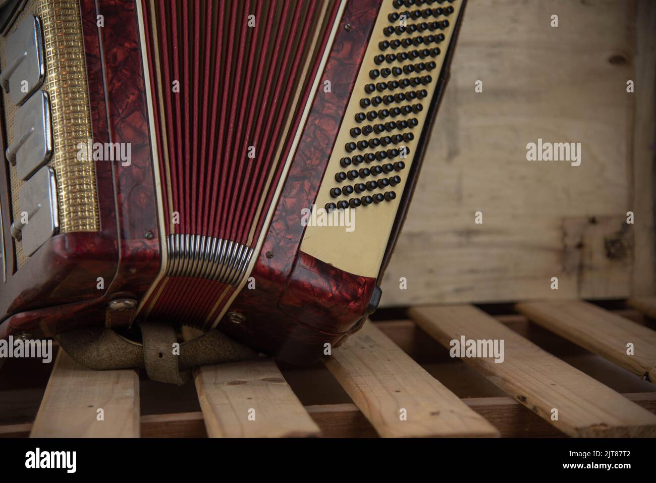 Old red accordion. Wind musical instrument. Old concertina