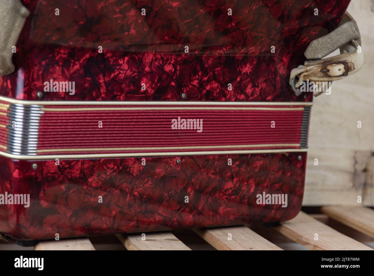 Old red accordion. Wind musical instrument. Old concertina. Musical