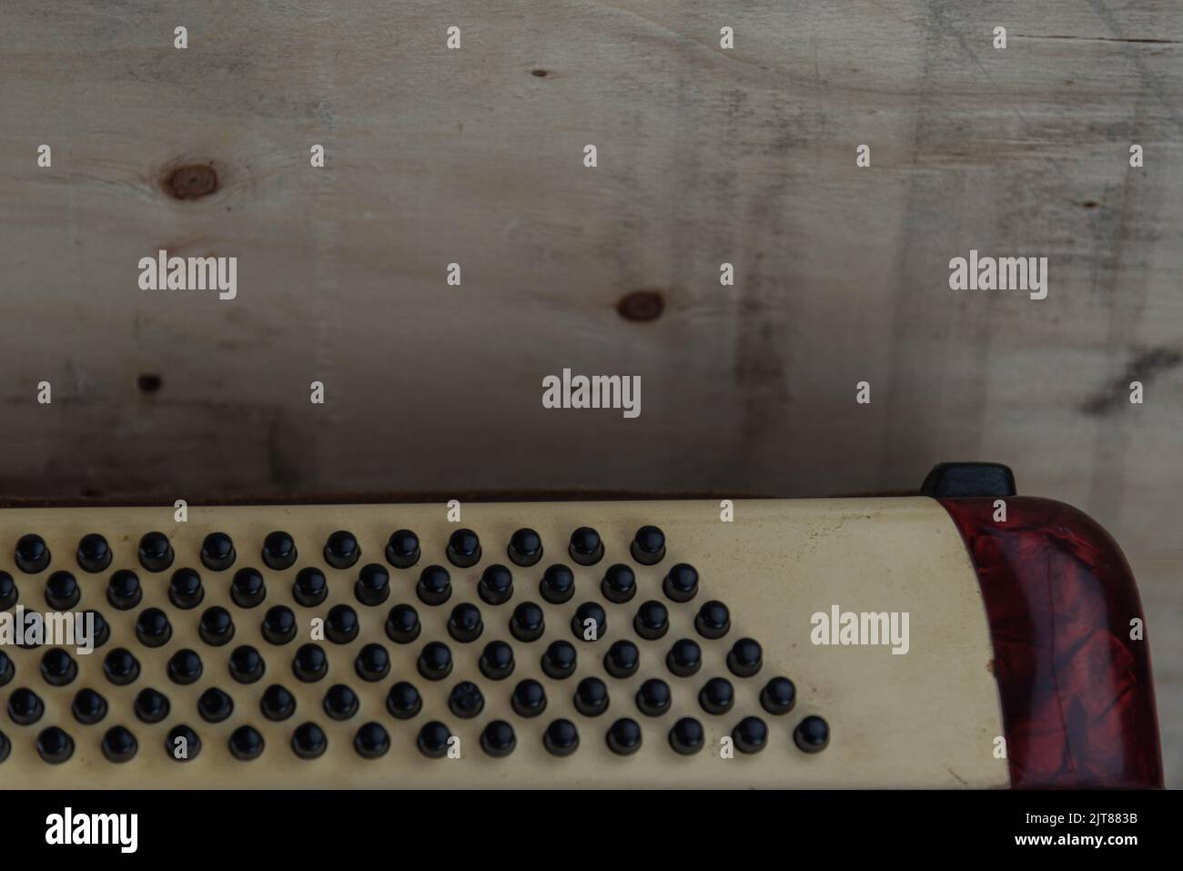 Old red accordion. Wind musical instrument. Old concertina. Musical