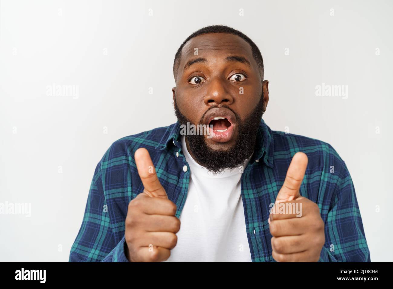 Portrait of happy afroamerican handsome bearded man laughing and showing thumb up gesture. Stock Photo