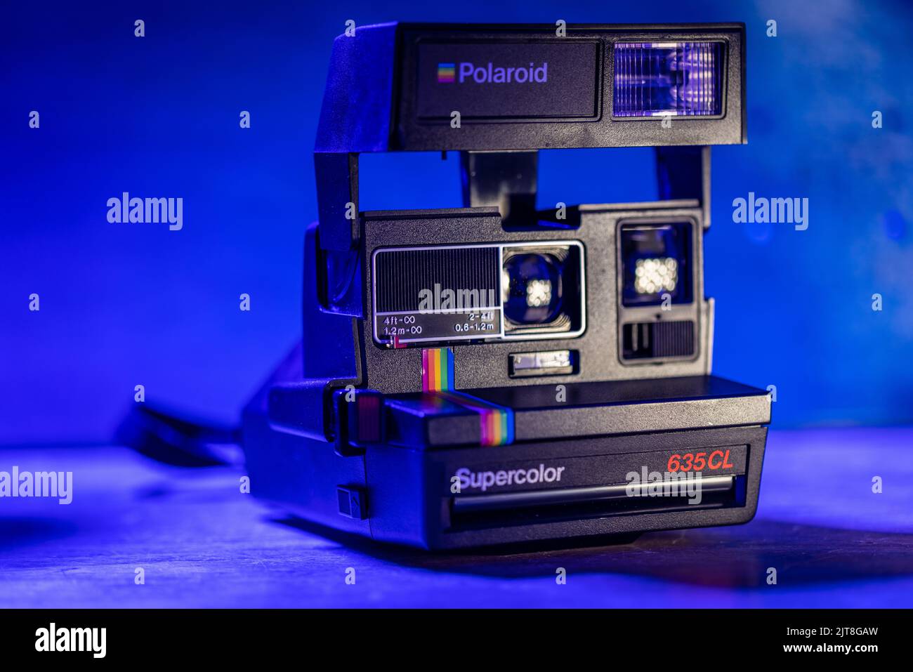 A closeup of a Polaroid Supercolor 635CL camera with blue background  lighting Stock Photo - Alamy