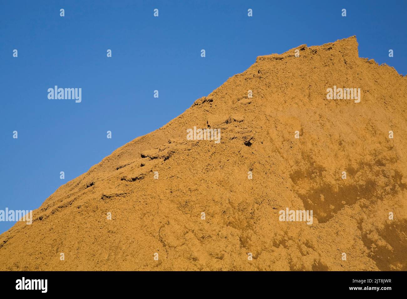 Close-up of a mound of sand in a commercial sandpit. Stock Photo