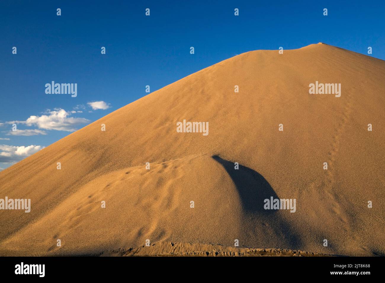 Mound of sand around sunset in a commercial sandpit. Stock Photo