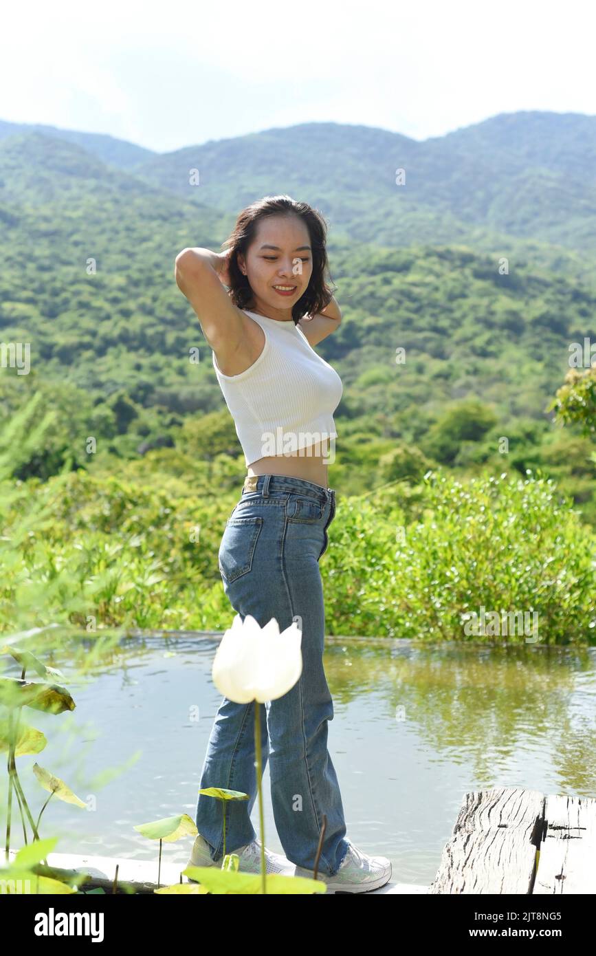 Young Vietnamese woman going for a stroll in a park Stock Photo