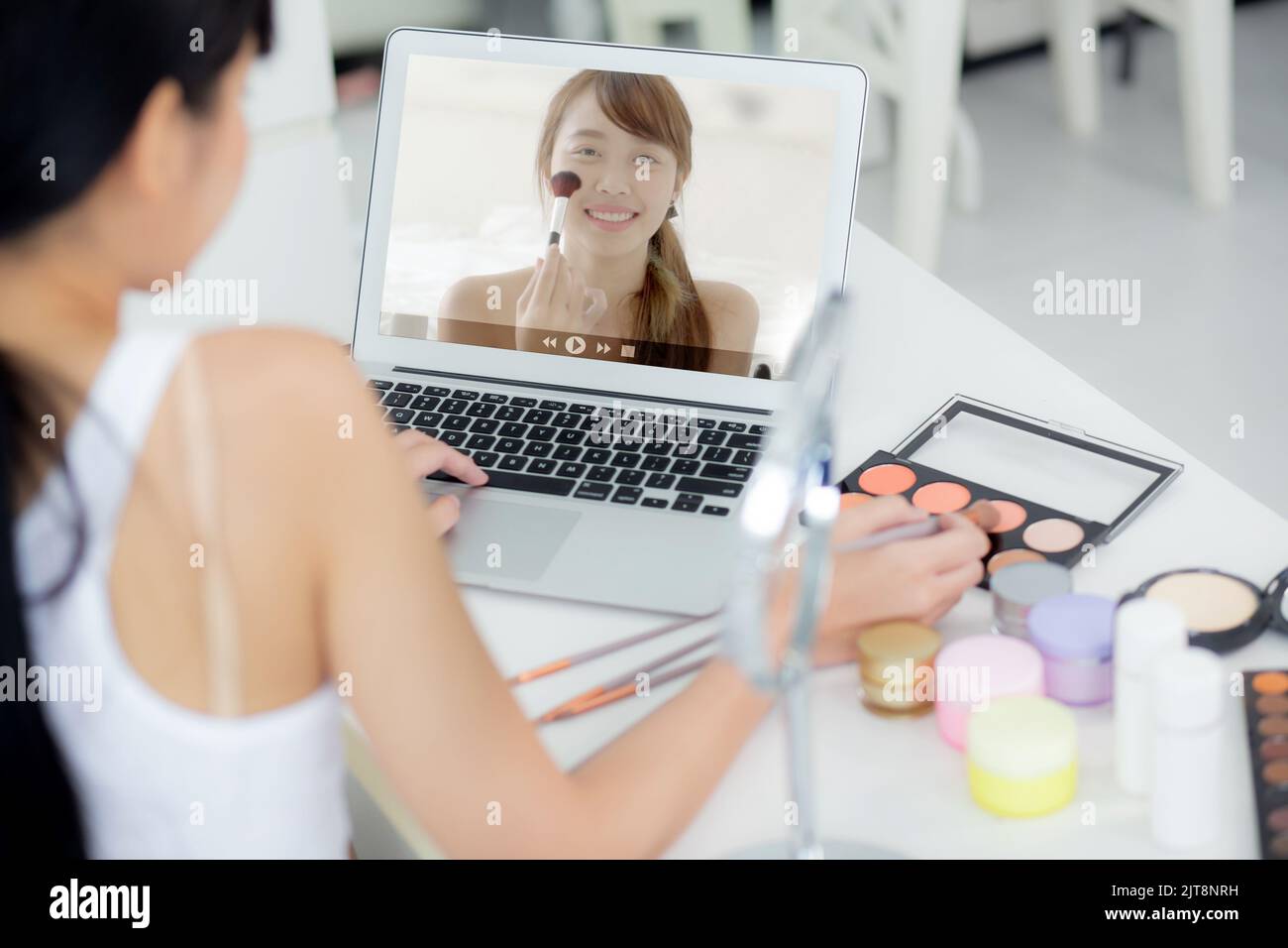 Beauty of young asian woman with learning makeup with brush on cheek on