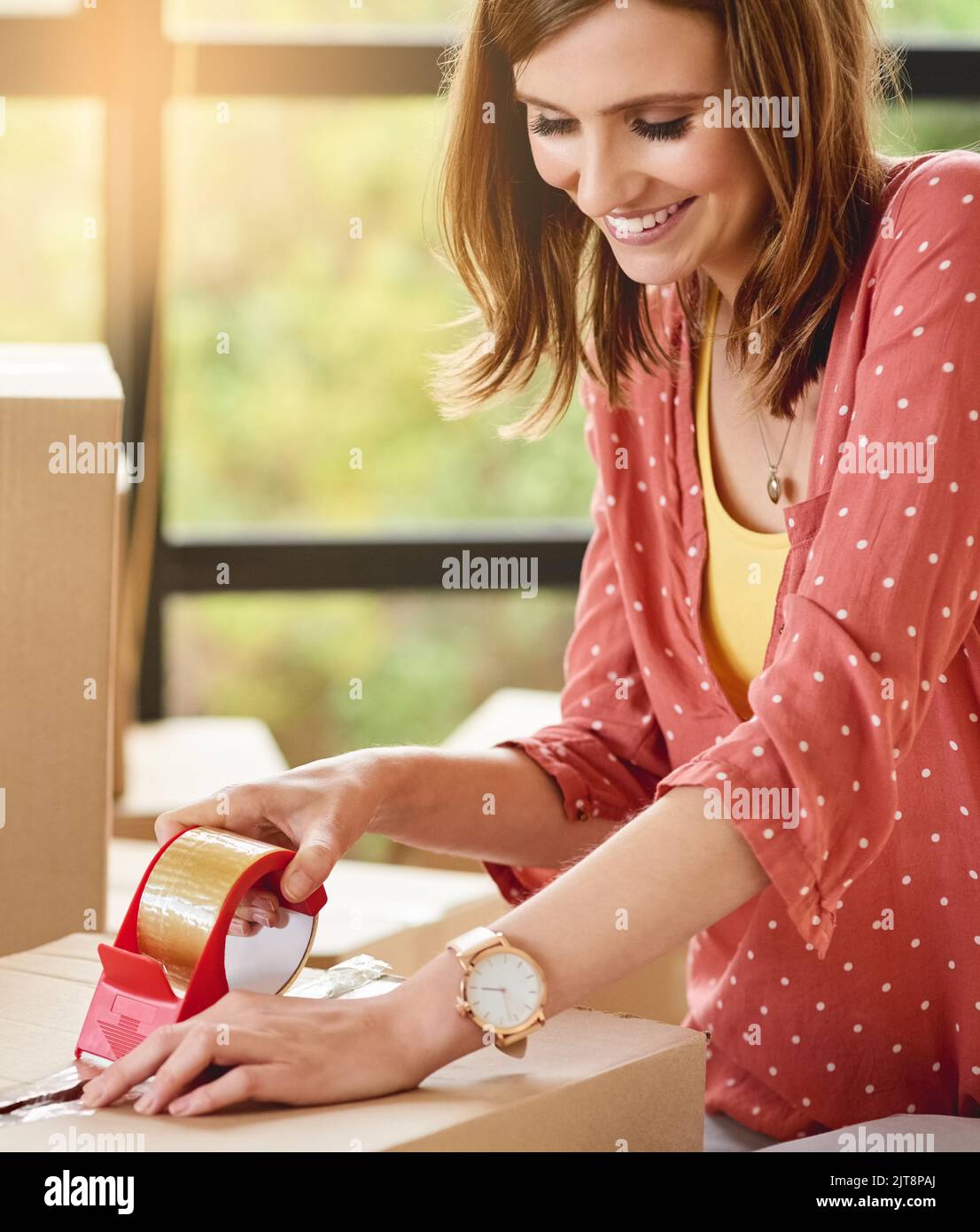Off to start a new beginning. a young woman packing boxes while moving house Stock Photo Alamy