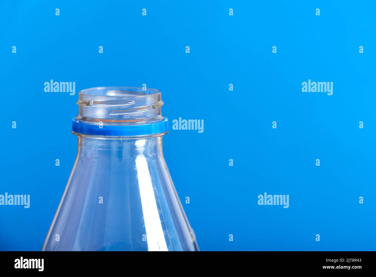 https://c8.alamy.com/comp/2JT8R43/top-of-an-empty-plastic-transparent-disposable-bottle-and-blue-background-concepts-sustainability-recycling-pollution-zero-waste-campaigns-2JT8R43.jpg