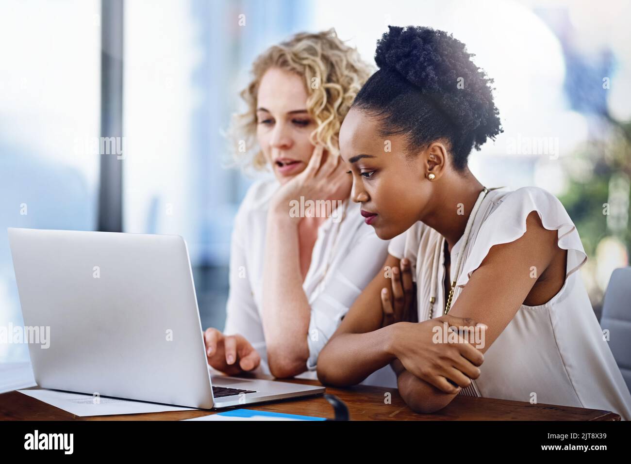 Working together to meet their objectives. two designers working together in the office. Stock Photo