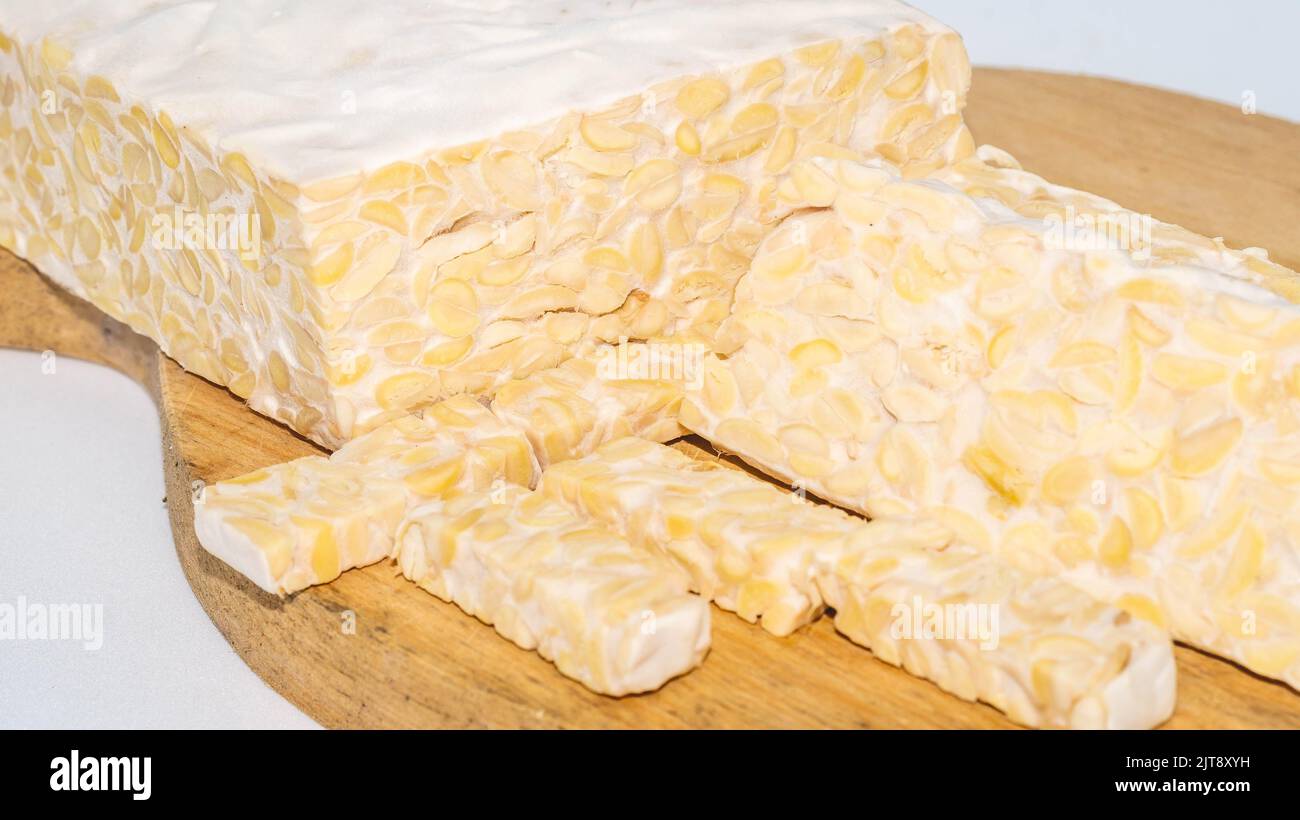 Raw slices of Tempeh, typical Indonesian food fermented made from fermented soybeans. Tempeh is