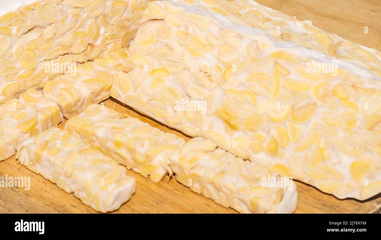 Raw slices of Tempeh, typical Indonesian food fermented made from fermented soybeans. Tempeh is