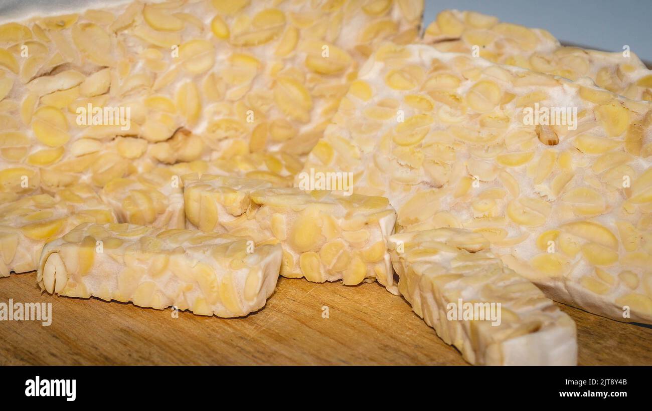 Raw slices of Tempeh, typical Indonesian food fermented made from fermented soybeans. Tempeh is