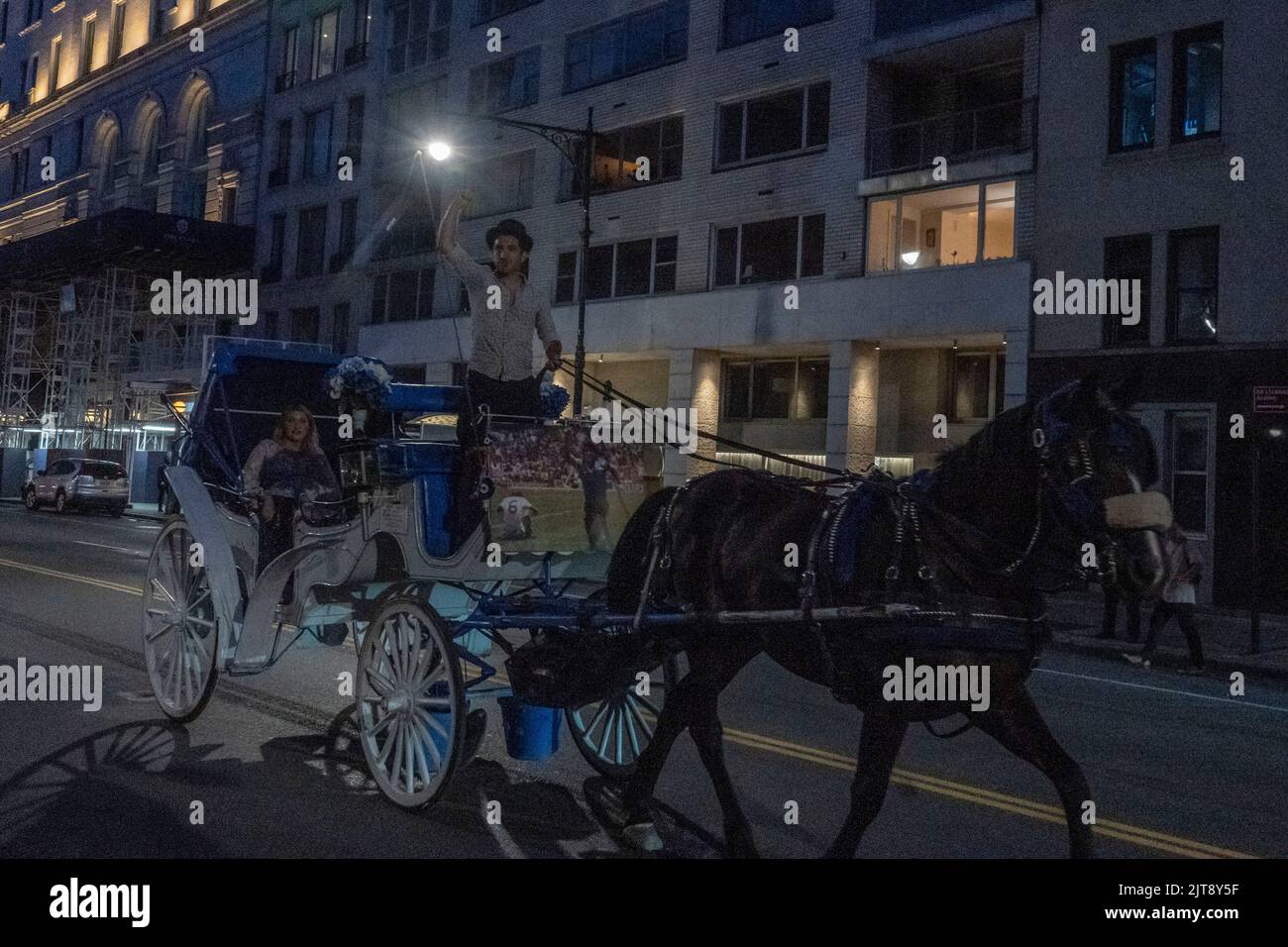 NEW YORK, NEW YORK AUGUST 27 A horse carriage driver raise his fist