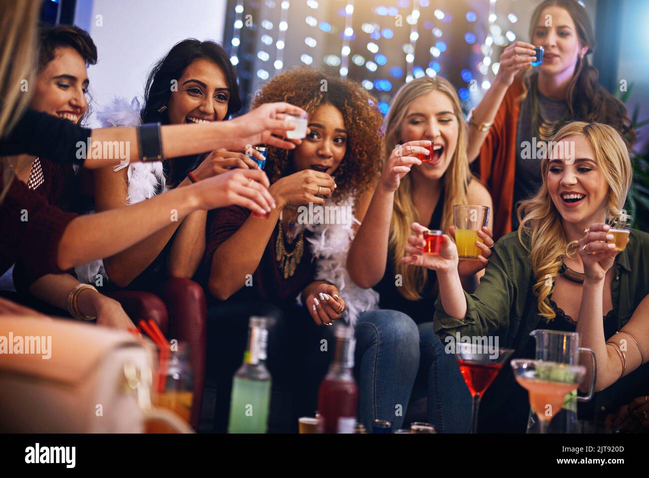Three, two, one - down. a group of friends having shots together at a party. Stock Photo