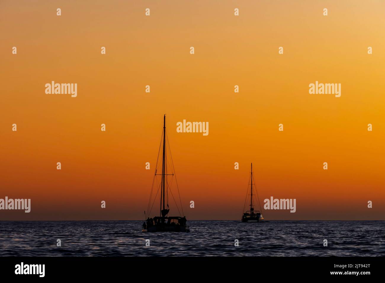 Sea yachts against the background of the sun reflected in the waves Stock Photo