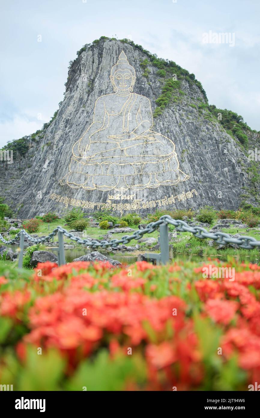 Pattaya landmark The Buddha Mountain at Khao Chi Chan, Na Chom Thian limestone hill Chonburi, Thailand.(Translation:Name of Budda image Phra Phuttha M Stock Photo