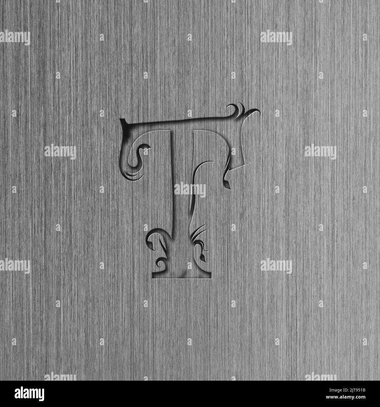 Macro shot of brushed steel with the letter T, metal texture background