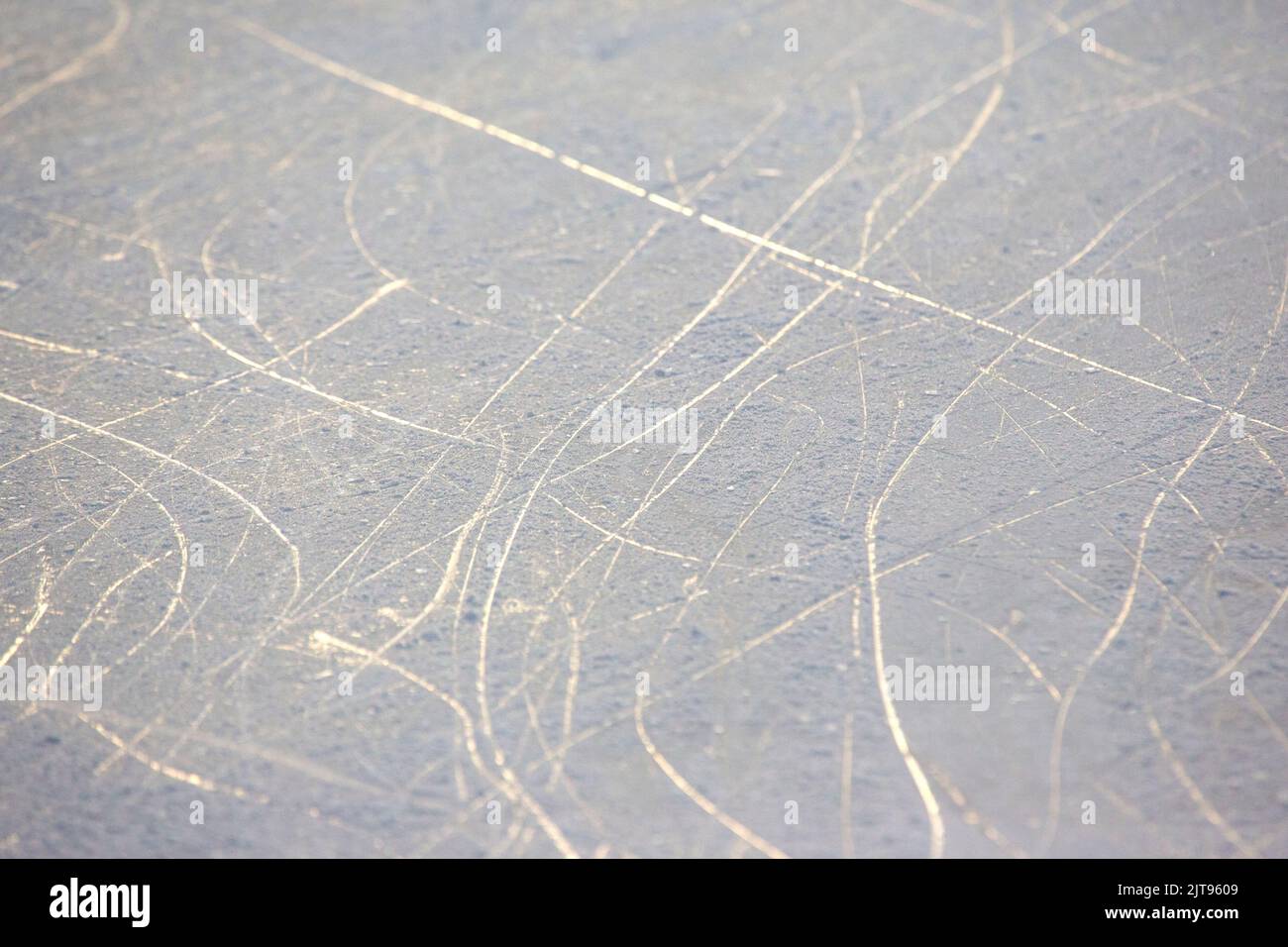 bright traces of ice skating on an ice rink. background and texture. reflection in the sunlight Stock Photo