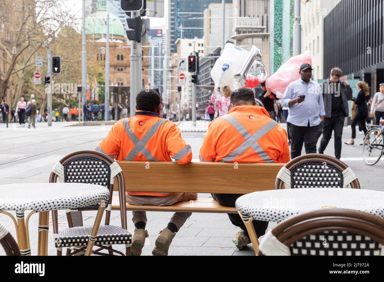 Sydney city centre, workers male wearing high viz visability orange tops take a work break,Sydney,Australia Stock Photo