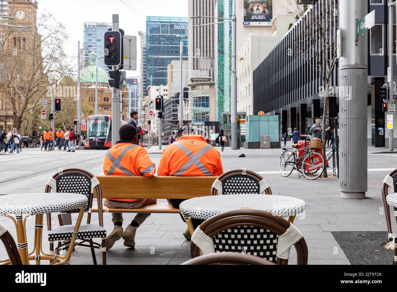 Sydney city centre, workers male wearing high viz visability orange tops take a work break,Sydney,Australia Stock Photo