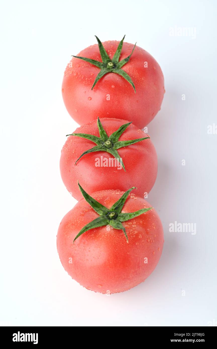 A closeup of ripe tomatoes isolated in white background Stock Photo - Alamy