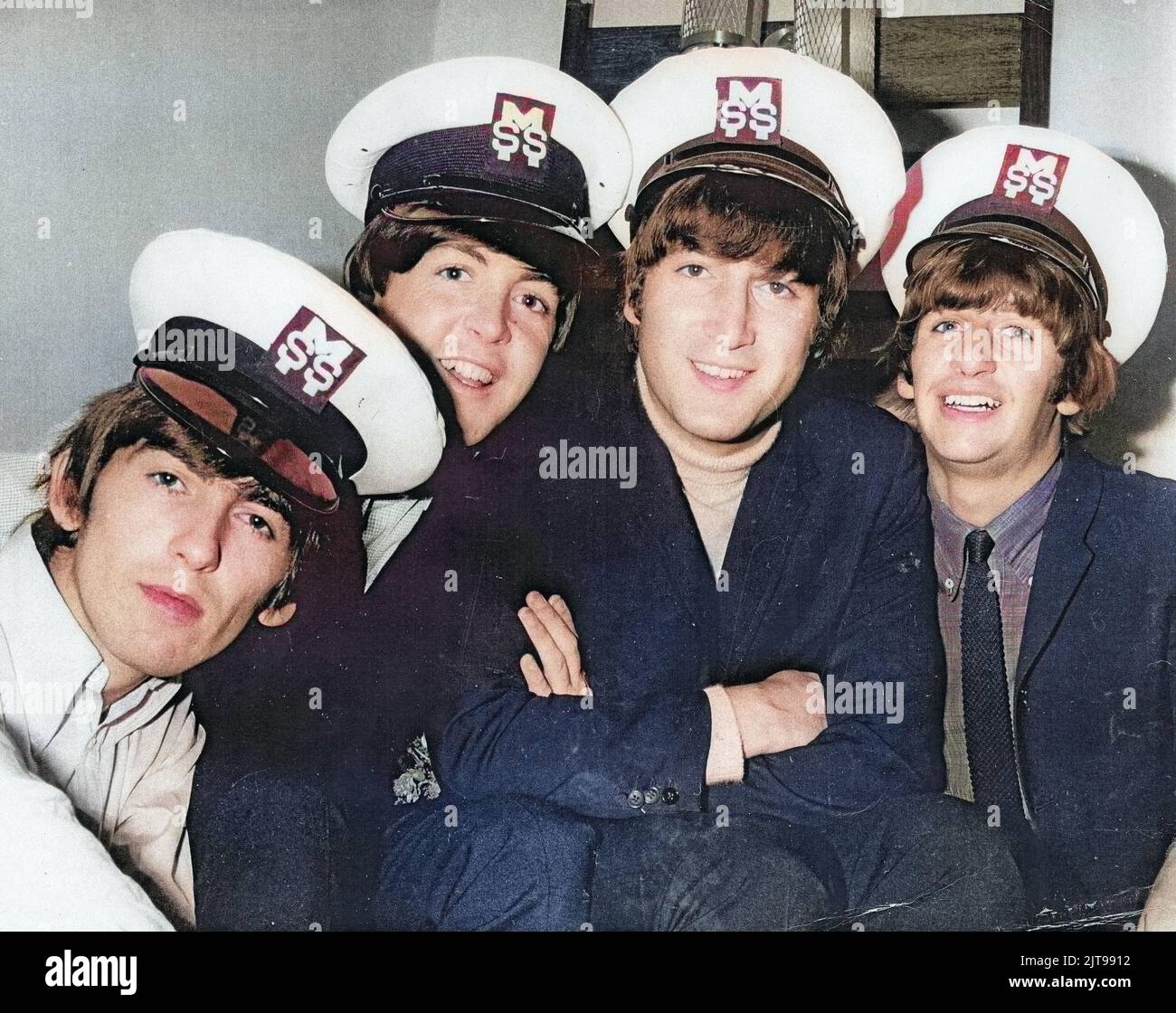 The Beatles wearing MSS caps on their 1964 tour of Australia. Devon Minchin's company MSS provided security for the band and he took personal charge. Colorized photo. Stock Photo