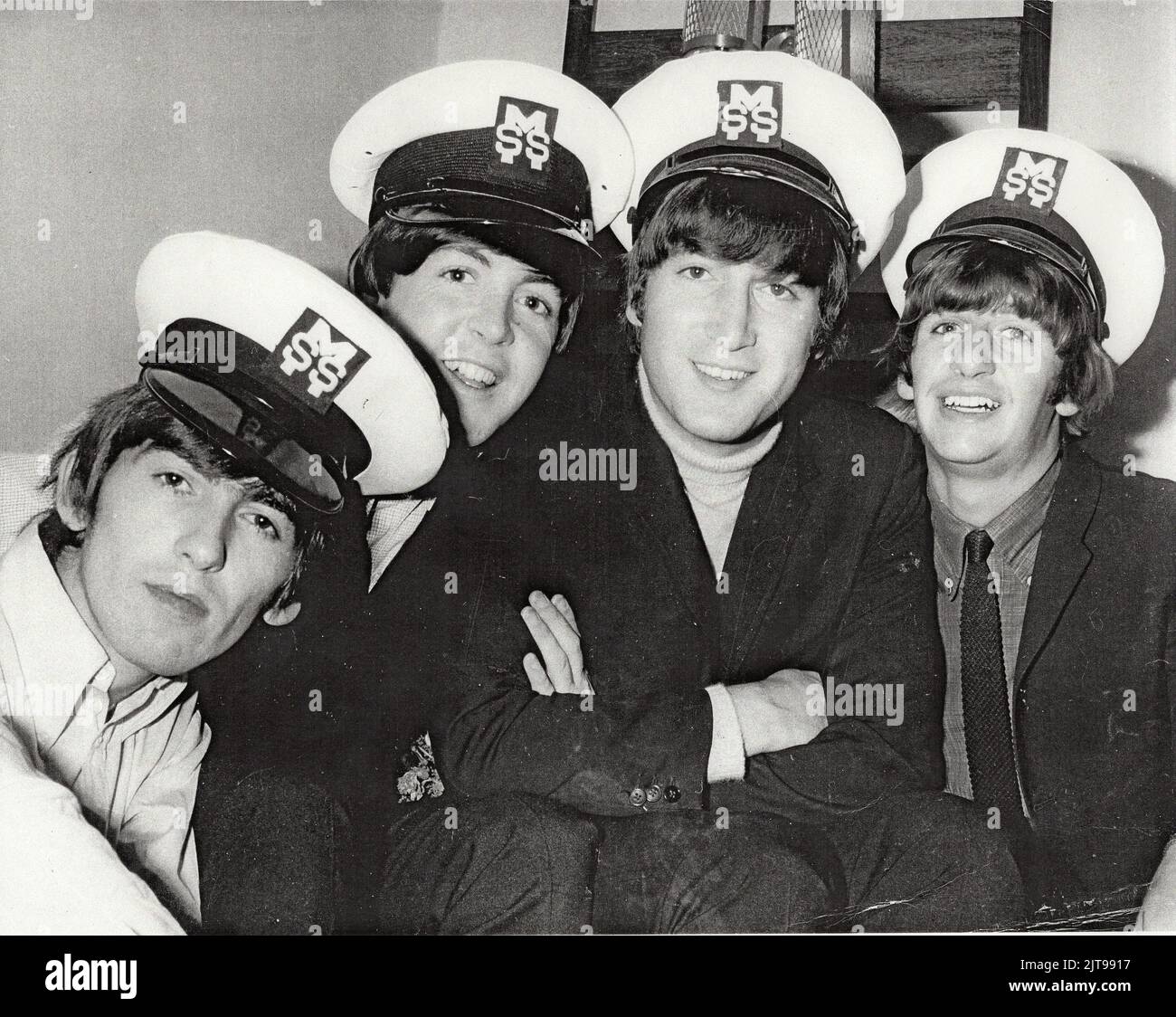The Beatles wearing MSS caps on their 1964 tour of Australia. Devon Minchin's company MSS provided security for the band and he took personal charge. Stock Photo
