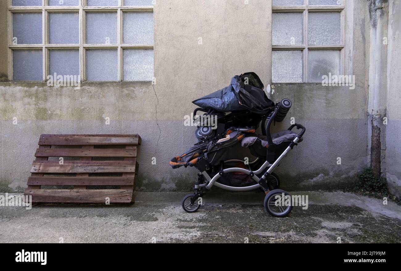 Detail of baby transport dumped on the street Stock Photo