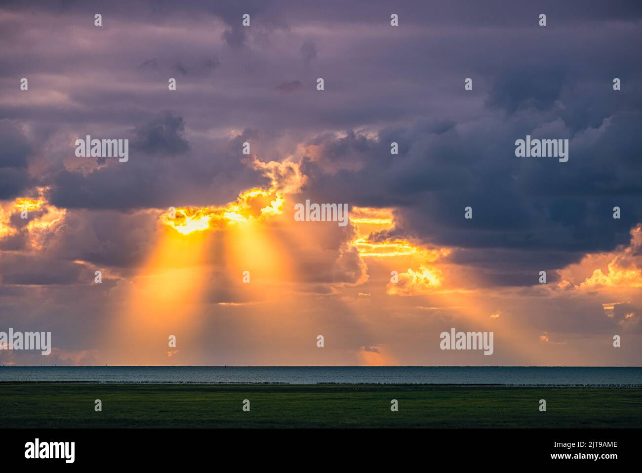Crepuscular rays (more commonly known as sunbeams, sun rays, splintered light, or god rays), in atmospheric optics, are rays of sunlight that appear t Stock Photo