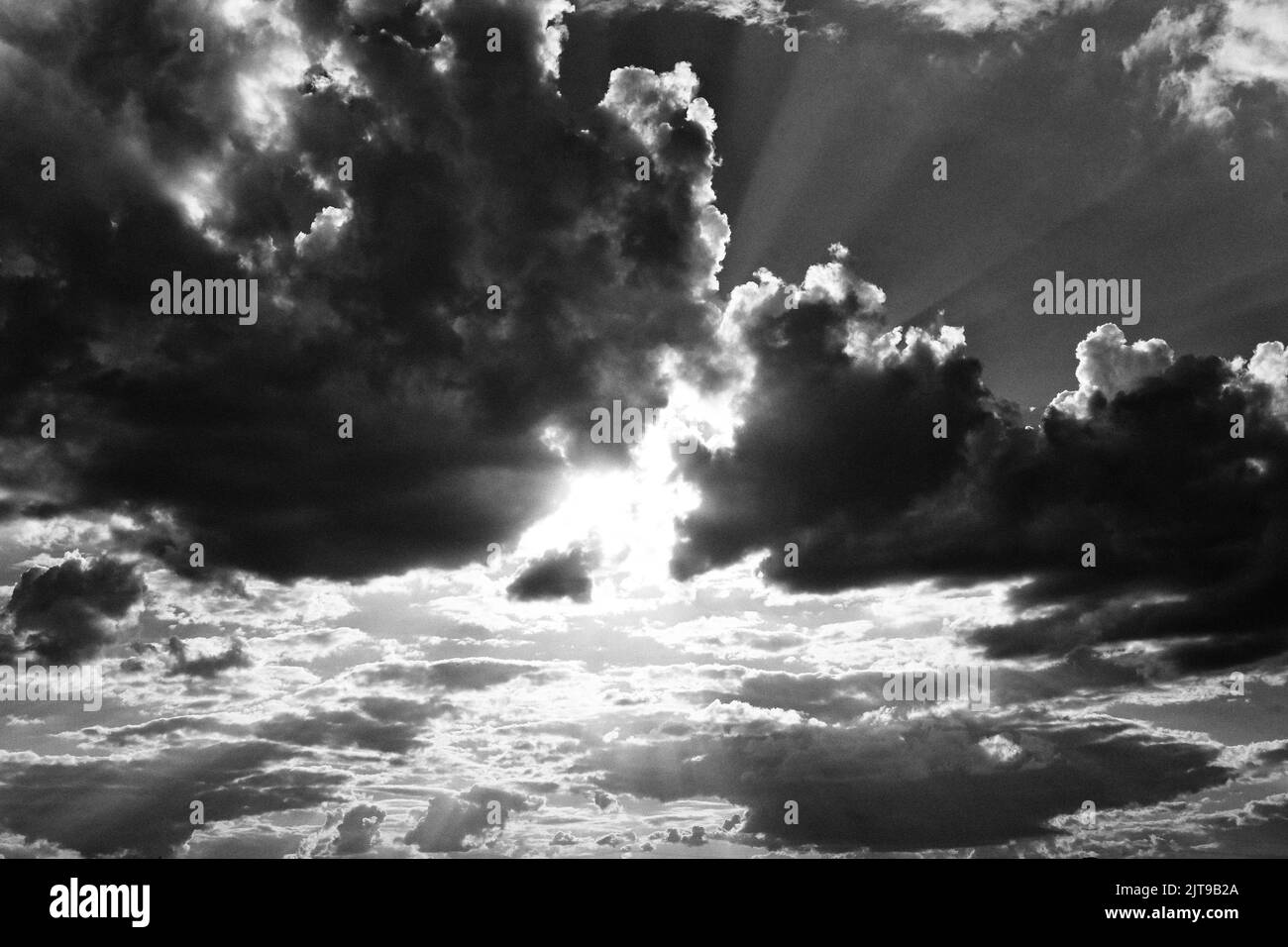 dark clouds with sun rays filtering through Stock Photo Alamy