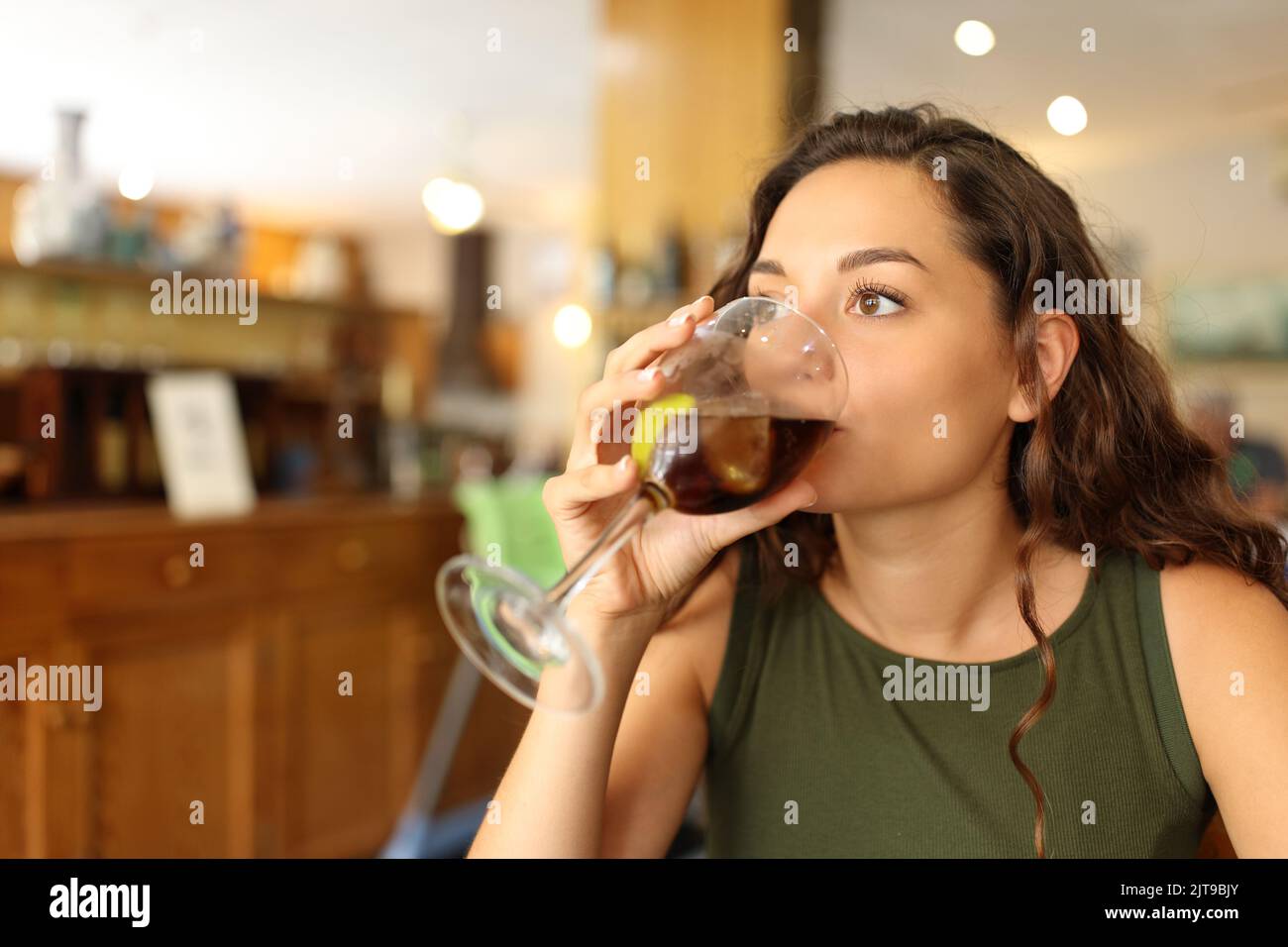 Woman drinking soda refreshment sitting in a restaurant Stock Photo