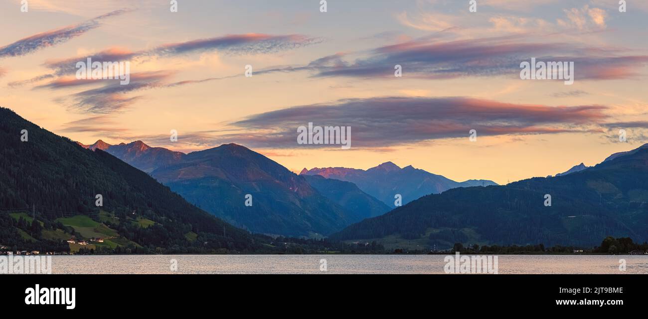A panoramic image from a summer sunset at Zell am See, located at the Zeller See, a lake in central Austria with access to Kaprun and the Großglockner Stock Photo