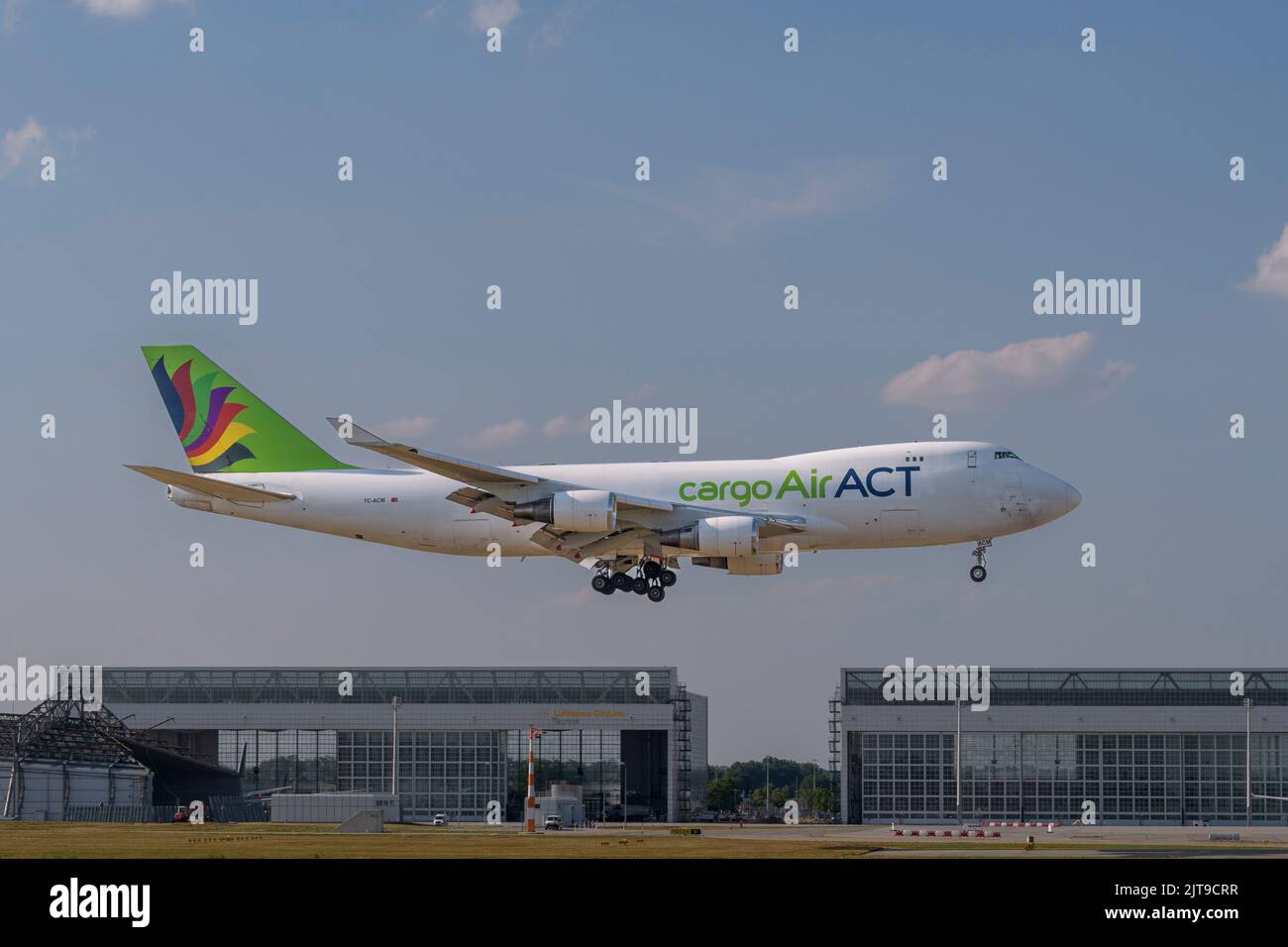 Munich, Germany - July 24. 2022 : ACT Airlines Boeing 747-428ERF with the aircraft registration TC-ACM is landing on the southern runway 08R of the Mu Stock Photo