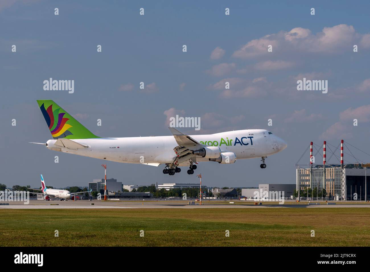 Munich, Germany - July 24. 2022 : ACT Airlines Boeing 747-428ERF with the aircraft registration TC-ACM is landing on the southern runway 08R of the Mu Stock Photo