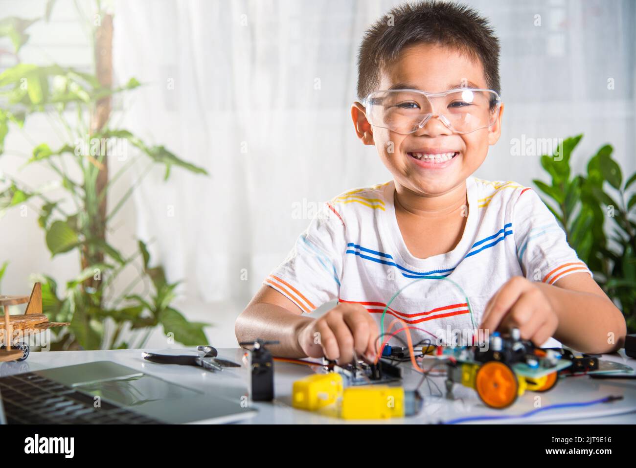 Little child remotely learn online with car toy before sent code, Asian