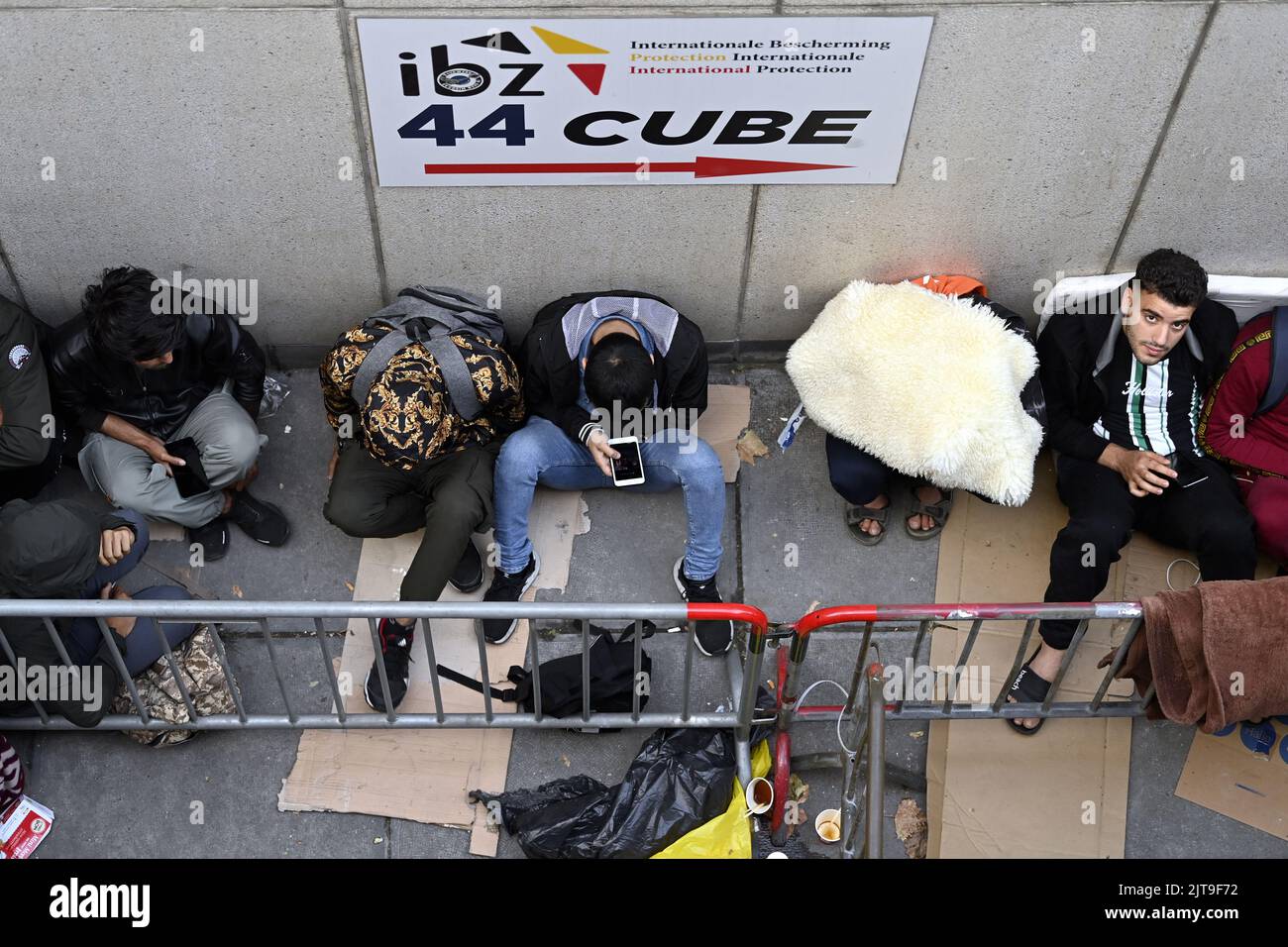 Brussels, Belgium. 29th Aug, 2022. Asylum seekers wait outside the
