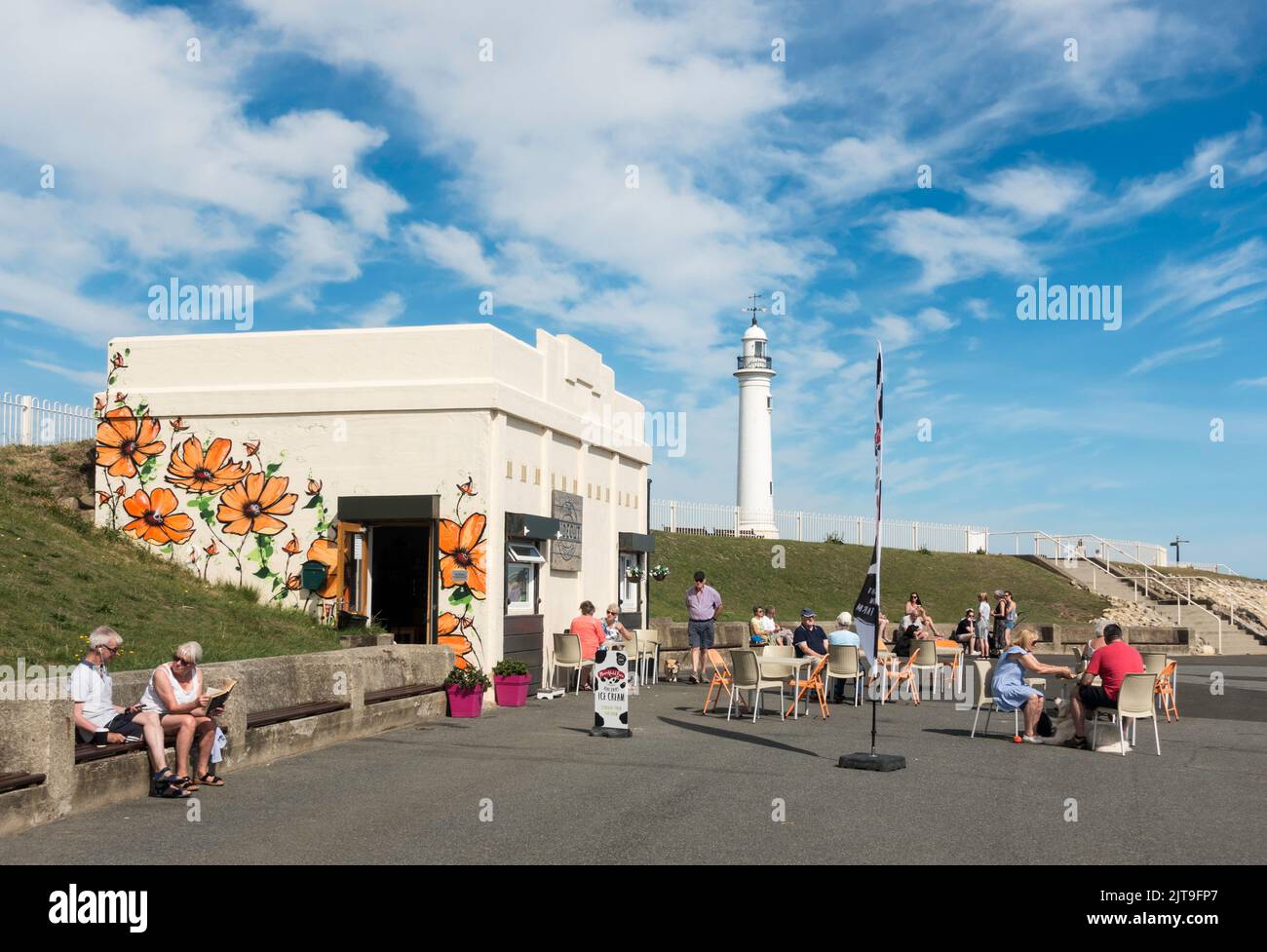 People enjoying a drink at the Hideout Coffee House or seafront café in Seaburn, during the August 2022 heatwave, Sunderland, England, UK Stock Photo