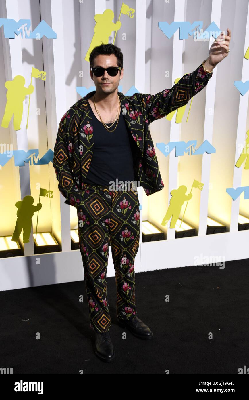 Dylan O'Brien walking on the black carpet at the 2022 MTV Video Music