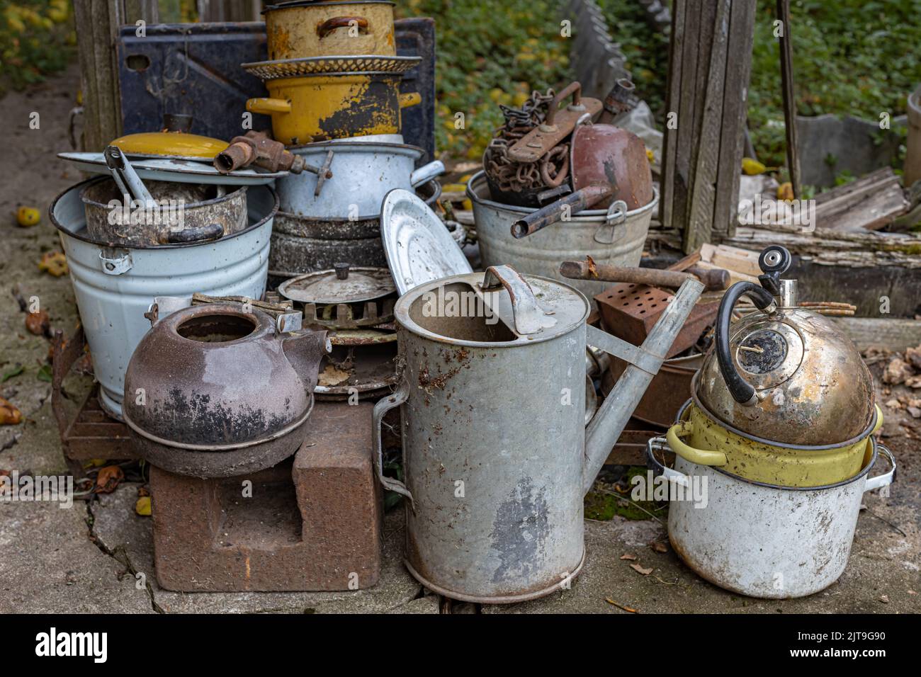 old garden and household equipment piled up. metal utensils and garden