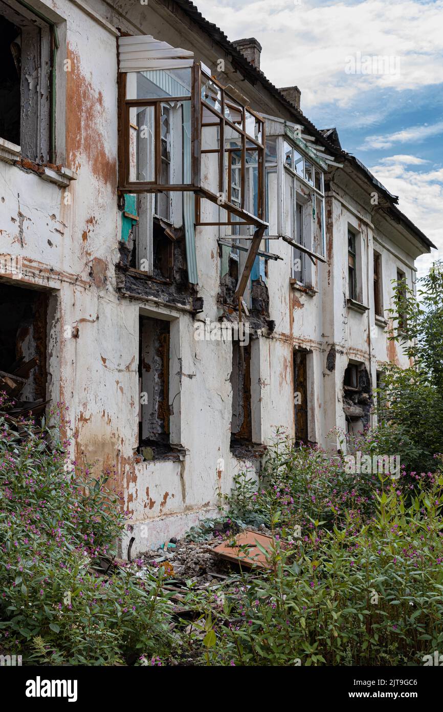 abandoned destroyed apartment building on the outskirts. a house with