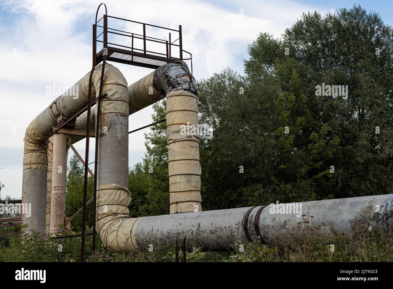 main pipe for water supply on the background of nature. wide pipe for